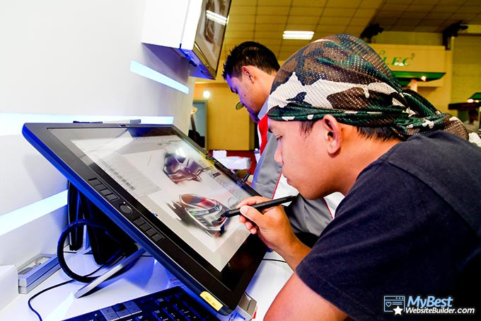 Artist websites: a man drawing a car on a tablet. Artist websites: a man drawing a car on a tablet.