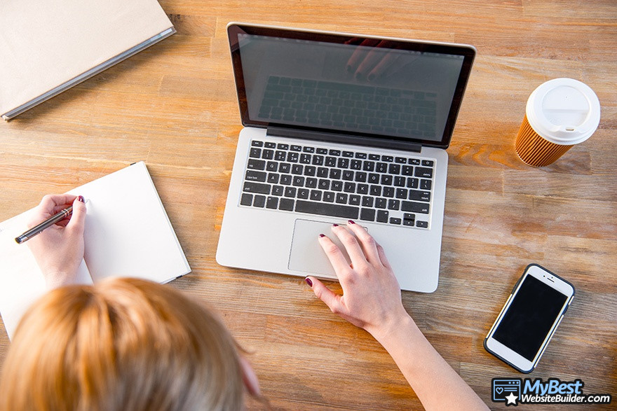 BigCommerce competitors: a woman typing in a laptop.