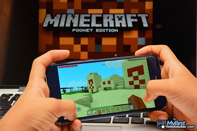 Free Minecraft server hosting 24/7: a person playing Minecraft's pocket edition.