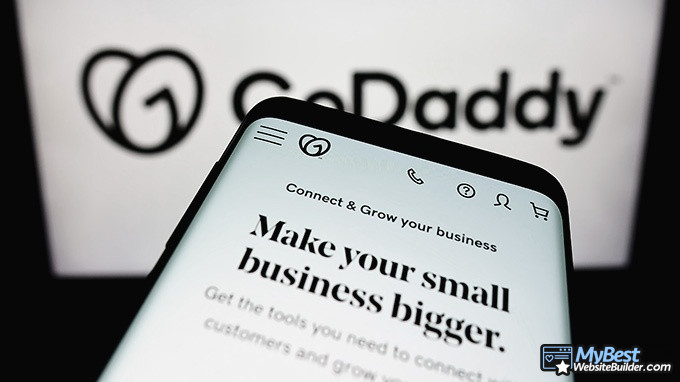 GoDaddy alternatives: GoDaddy logo on a computer screen and GoDaddy website on a phone screen.
