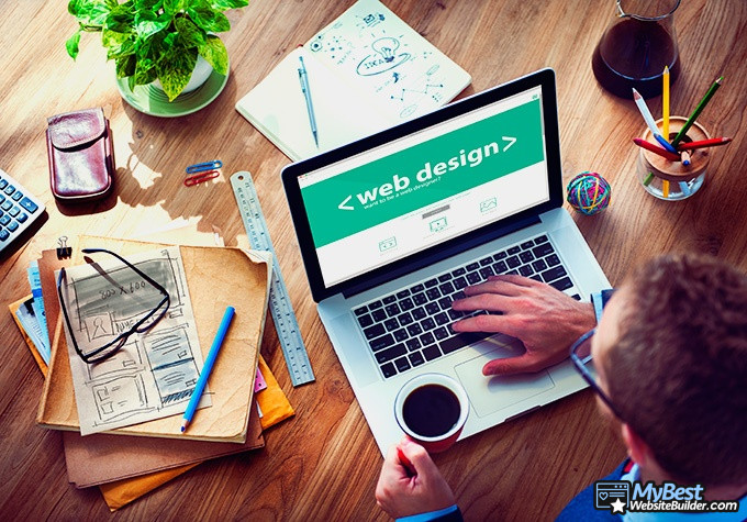 GoDaddy alternatives: web designer working on a laptop.