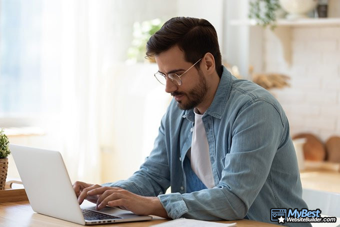 What is a domain name: man working on computer.