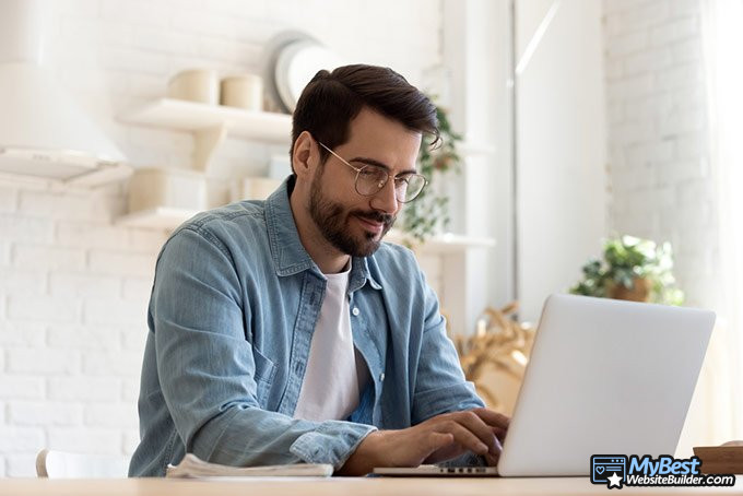 What is a domain name: man working near computer.