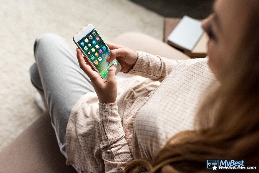 Webflow VS WordPress: a woman holding a smartphone. Webflow VS WordPress: a woman holding a smartphone.