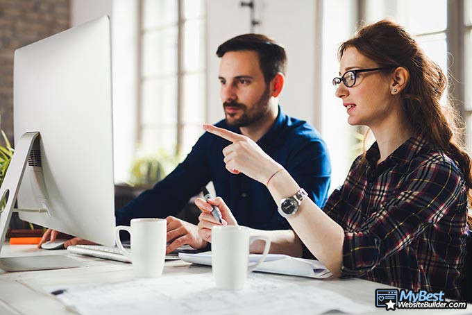 Website layouts: a man ad woman talking about website layouts. Website layouts: a man ad woman talking about website layouts.